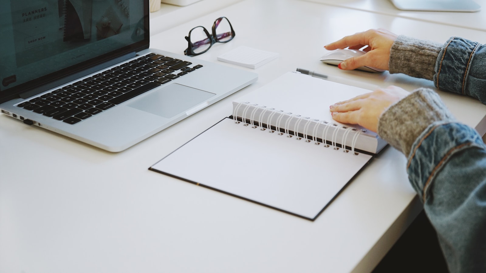Person touching a notebook while thinking through a link building decision