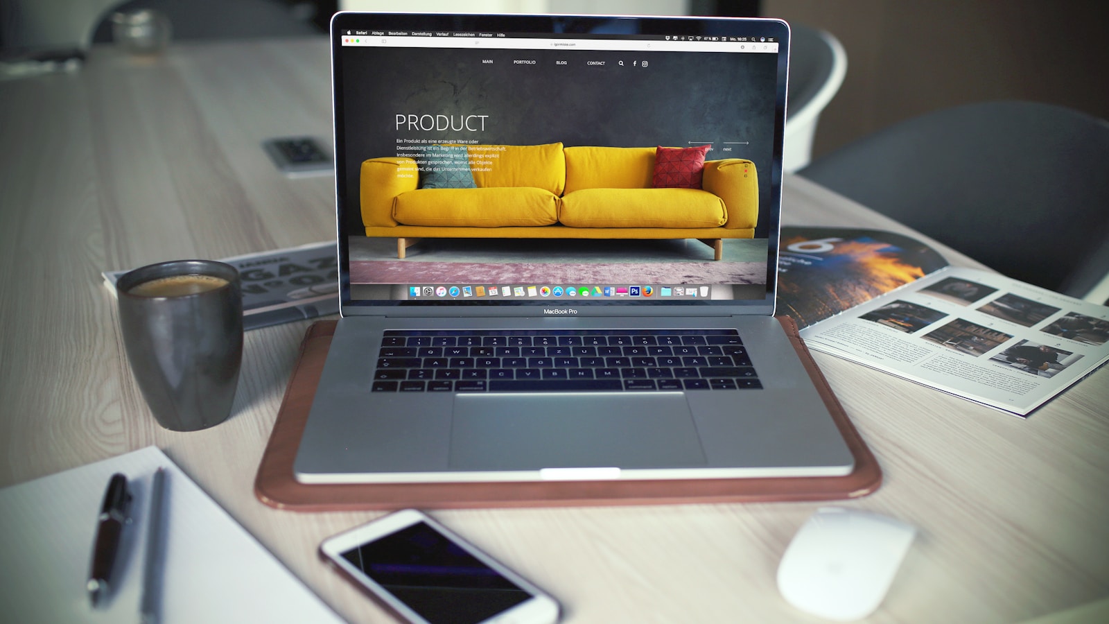 MacBook on a desk with a mug, representing a workspace where an ecommerce link building plan is prepared