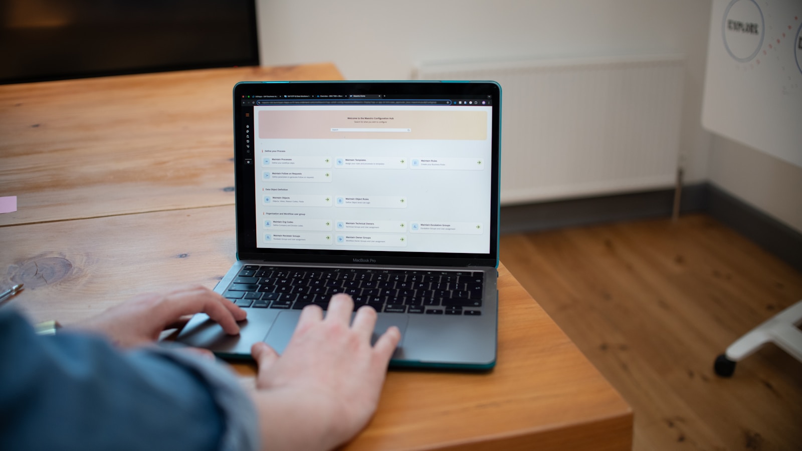 A person typing an outreach email on a laptop at a wooden desk, representing the research and writing work behind link building outreach