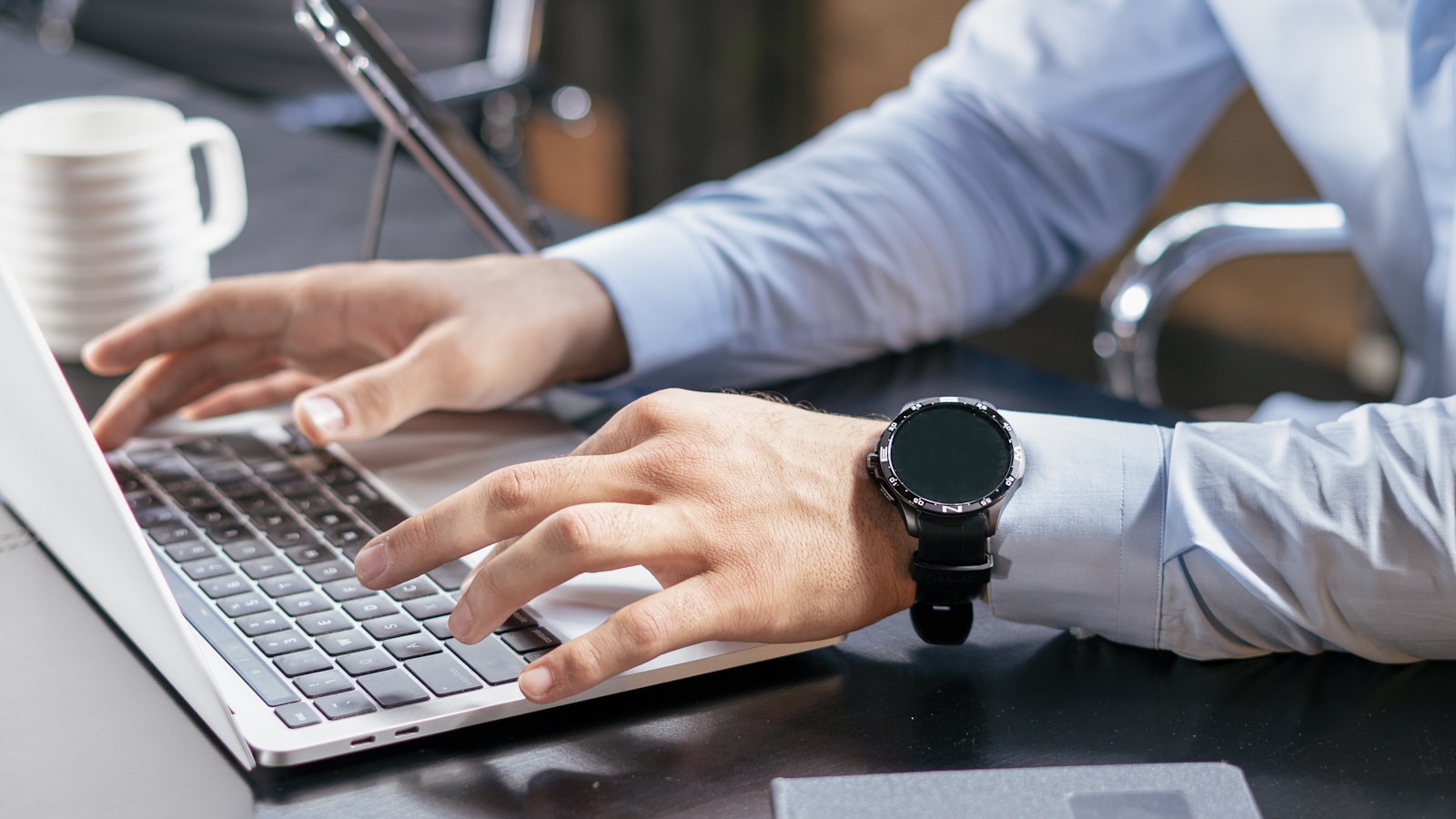 Person typing on a laptop at a desk, evaluating the health of a website's link profile
